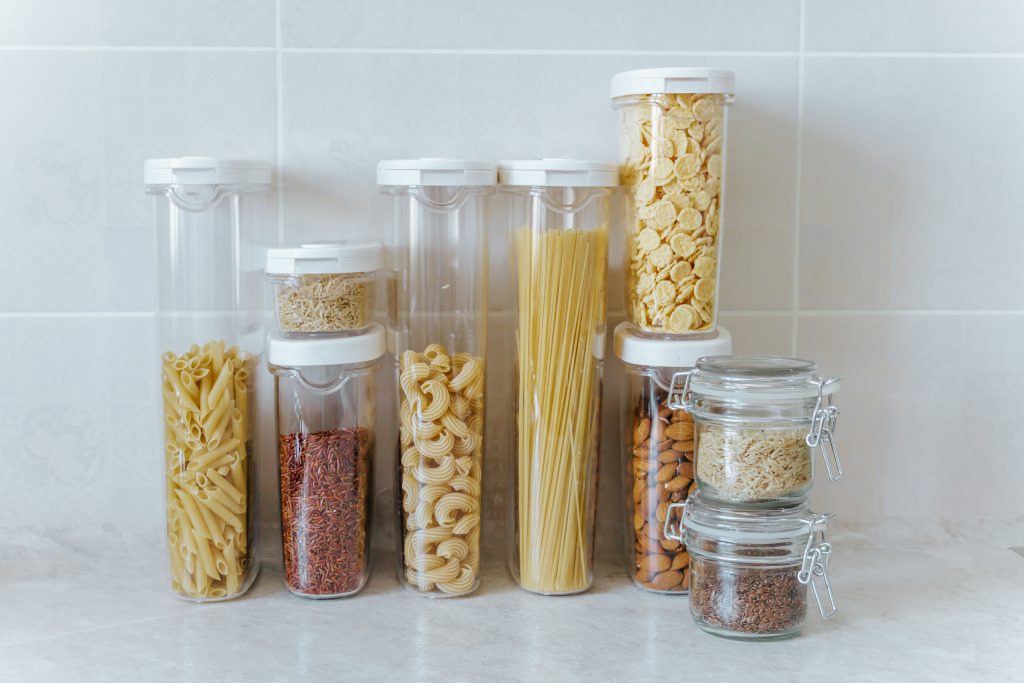 A variety of pasta, rice, cereals, nuts in containers-cans. The concept of proper convenient rational storage of food in the kitchen